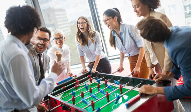 istock Coworkers playing table football on break from work 1162153294