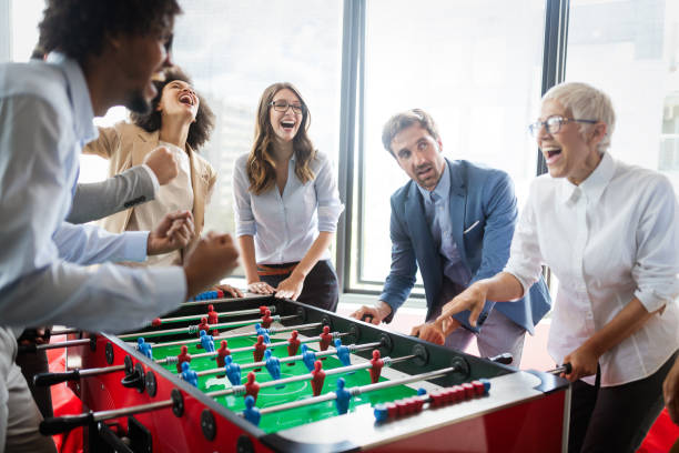 istock Employees playing table soccer indoor game in the office during break time 1162153318
