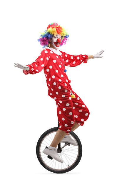 istock Cheerful clown riding a unicycle 1162153427
