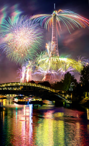 This long exposure shot was taken in Paris during Bastille Day. It shows the National Celebration fireworks in front of the Eiffel Tower, with some refections on the Seine river.