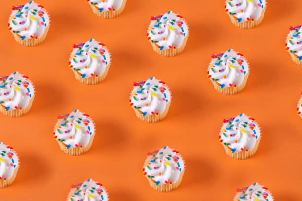 cupcakes on orange background. - birthday cupcake pastry baking imagens e fotografias de stock
