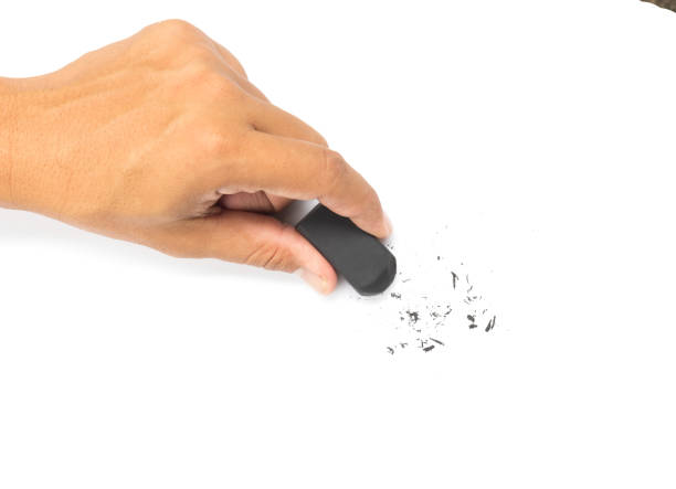 hand holding black eraser  on white background. stock photo