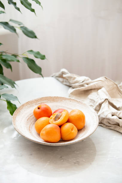 Wicker basket apricot on a marble background with copy space and daylight
