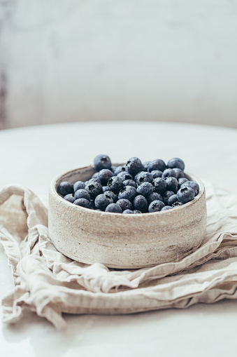 Blueberry bowl on white background with copy space in rustic style