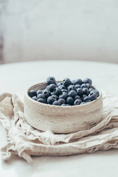 Blueberry bowl on white background with copy space in rustic style stock photo