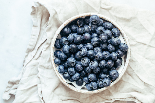 Blueberry bowl on white background with copy space in rustic style
