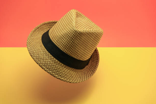 istock Beautiful straw hat on a peach and yellow background. 1162157498