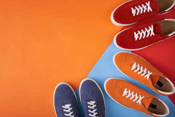 istock Colorful casual unisex suede trainers standing on multicolored background 1162157661