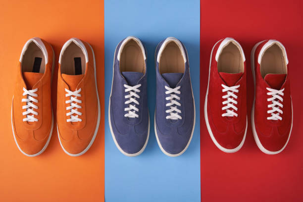 istock Colorful casual unisex suede trainers standing on multicolored background 1162157896