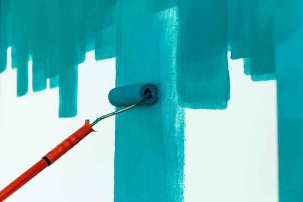 istock Strips of paint on a white wall and roller. 1162159421