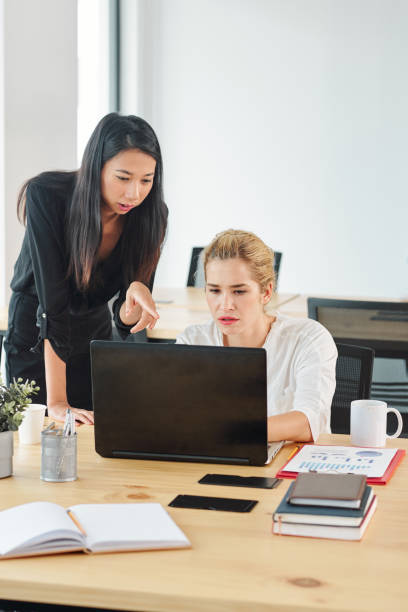 istock Businesswomen using laptop at office 1162160296
