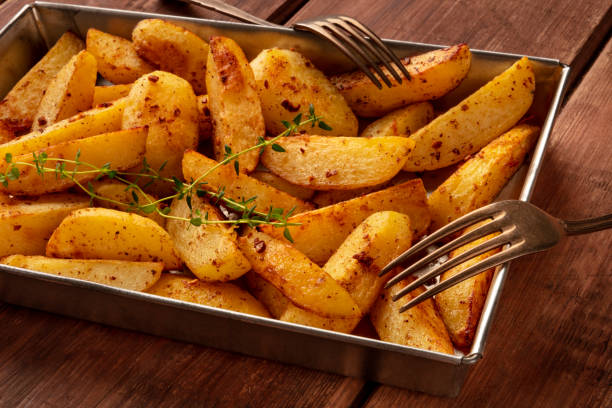 istock Potato wedges, oven roasted, close-up in baking tray 1162160500