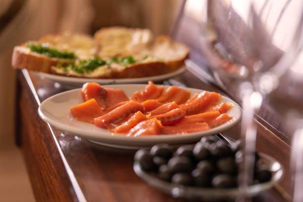 romantic dinner . dishes are on the piano: fish, olives, glasses.