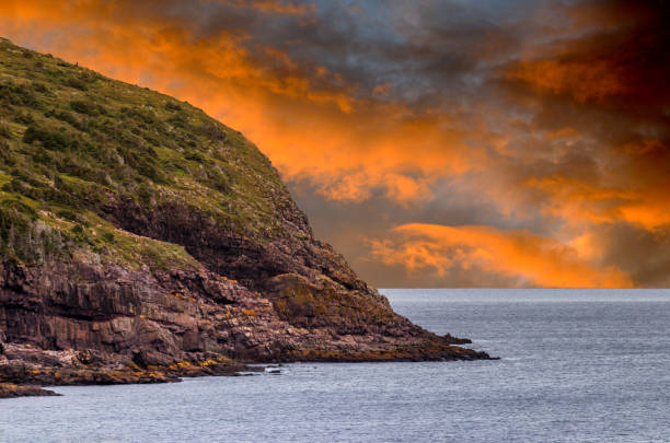 Hill on the ocean at sunrise neat Port Spear, Newfoundland, Canada stock photo
