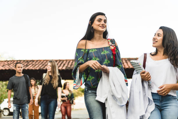 istock College students walk relaxed on university campus 1162161630