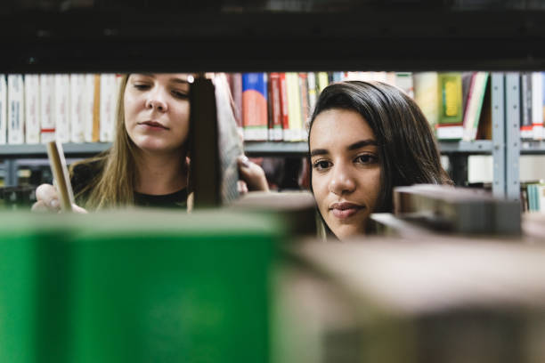 istock Students consult books in the university library 1162161640