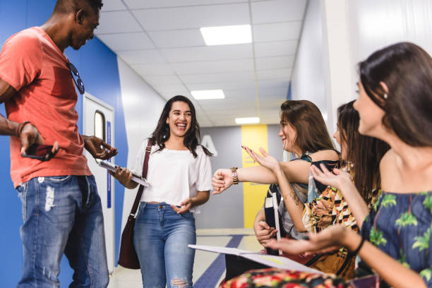 istock College students play with late student 1162161667