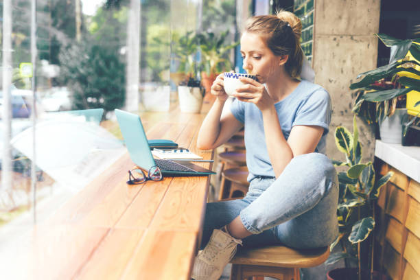 istock Girl in a cafe with a laptop 1162164888