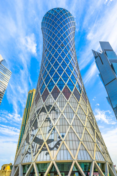 Tornado Tower Doha Doha, Qatar - February 17, 2019: Tornado Tower with image of Emir Tamim bin Hamad al-Thani, iconic glassed high rises in West Bay. Skyscraper of Financial District in Middle East, Persian Gulf. qatar emir stock pictures, royalty-free photos & images