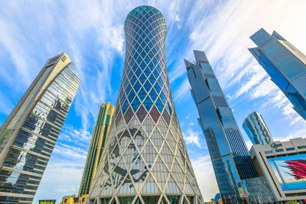 Doha Tornado Tower Doha, Qatar - February 17, 2019: Tornado Tower with image of Emir Tamim bin Hamad al-Thani. High rises in West Bay. Skyscrapers of Financial District in Middle East, Persian Gulf. qatar emir stock pictures, royalty-free photos & images