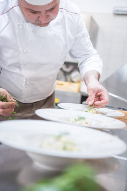 istock Chef Preparing Traditional Italian Risotto with Asparagus and Pancetta 1162168631
