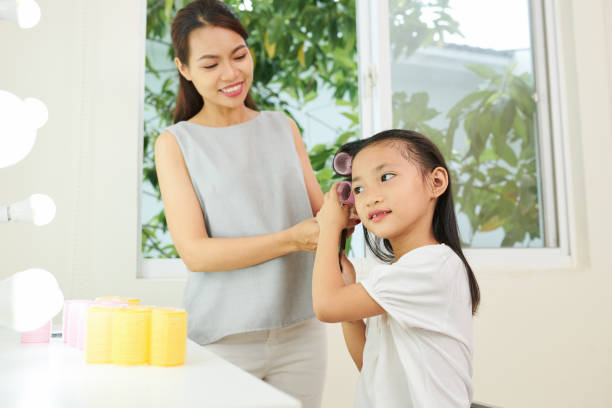 istock Mother and daughter doing hairstyle 1162168690