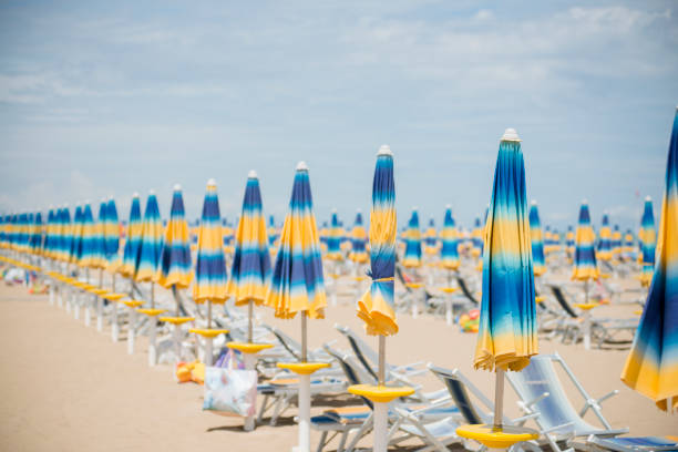 Colorful umbrellas in the sunlight on a sandy beach on the Italian Adriatic coast (Abruzzi Provice)