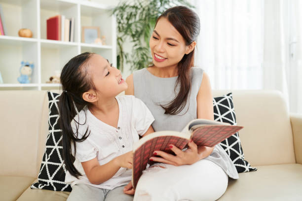 istock Family reading a book at home 1162169404