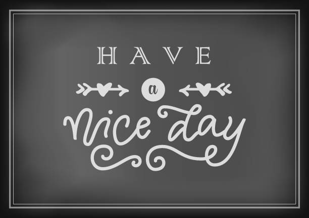 istock lettering of Have a nice day in white with arrows and hearts on chalkboard 1162169412