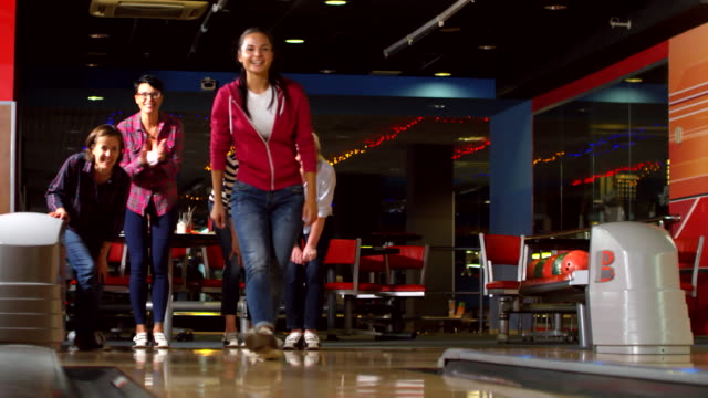 Happy Women Playing Bowling Together