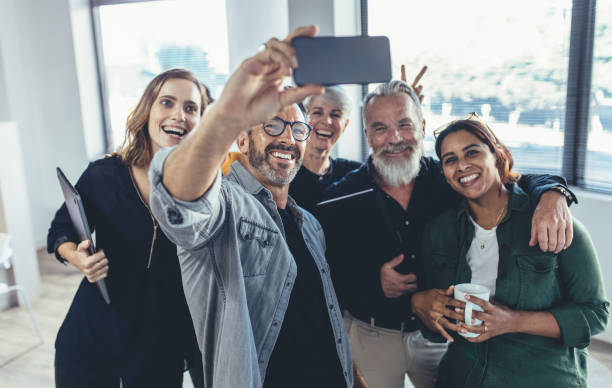 istock Cheerful people in the office taking selfie 1162172601