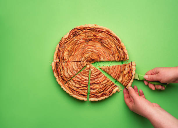 istock Woman hand cutting an apple pie. Home-baked sweets 1162174270