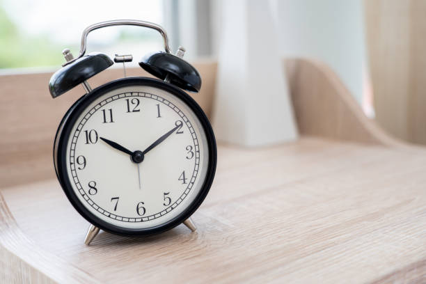 istock Vintage Black Alarm clock on table in bedroom 1162174438