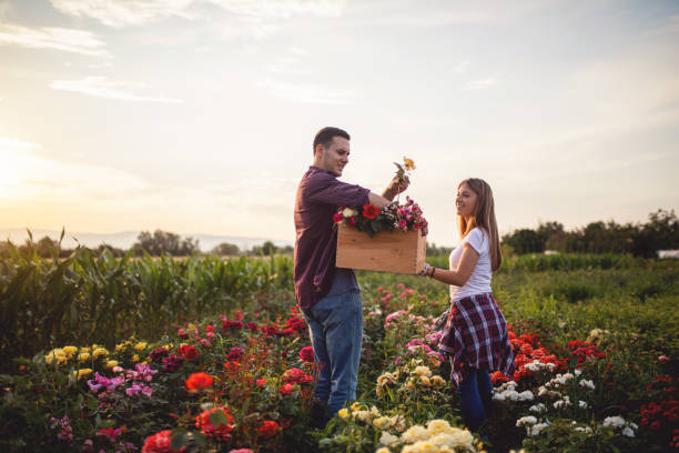 istock Couple picking flowers together 1162174590