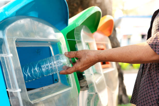 istock old women hand throwing away the garbage to the bin/trash, sorting waste/garbage before drop to the bin 1162176893