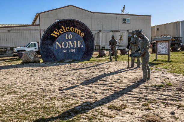 Gold Pan and Prospectors Nome, AK, USA - June 10, 2019- The Gold Panning memorial with the three lucky Swedes statues as seen in Nome Alaska. alaska gold rush stock pictures, royalty-free photos & images