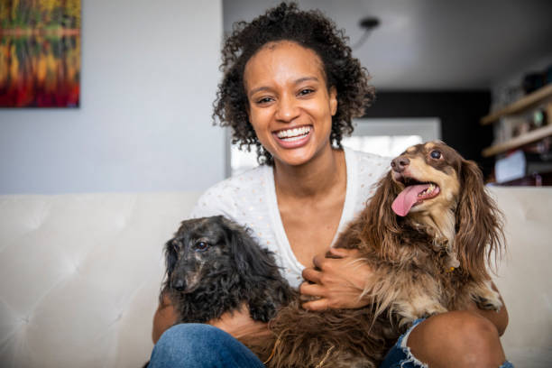 Young Black Woman with Pet Dachshunds