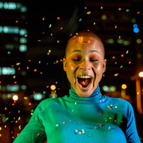istock Cool woman under a rain of confetti 1162190643