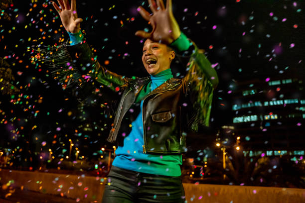 istock Cool woman under a rain of confetti 1162190647