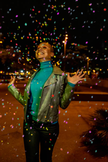 istock Cool woman under a rain of confetti 1162190650