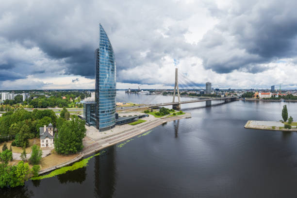 River Daugava photographed before storm. The Swedbank building called Saules Akmens is in the foreground. AB dambis pier can also be seen. Old Town Riga is in the background