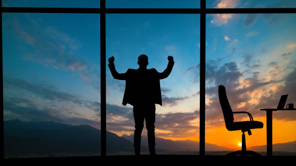 The man standing near the window on a mountain sunset background The man standing near the window on a mountain sunset background pool break stock pictures, royalty-free photos & images