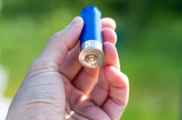 Used fired shell, empty shot gun bullet cartridge in the arm Selective focus