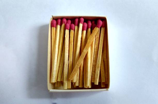 istock Box of red matches with white background 1162194030
