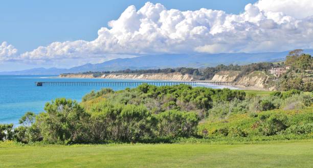 Golf Course Overlooking Ocean and Pier in Santa Barbra California Golf Course Overlooking Ocean and Pier in Santa Barbra California. Perfect balance of white clouds, grass, and ocean pier that are laid out in a parallel pattern. santa barbara california photos stock pictures, royalty-free photos & images