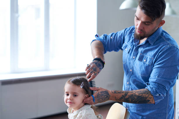 istock Brutal man doing hairstyle to little daughter 1162196318