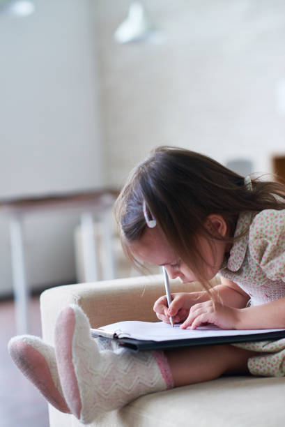 istock Lovely girl drawing on clipboard 1162196480