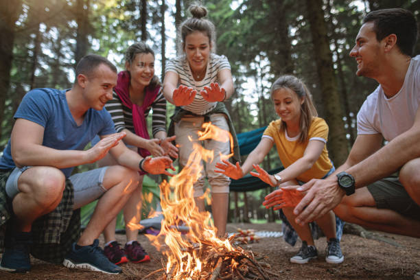 istock Group of friends sitting by the fire, telling stories 1162196709