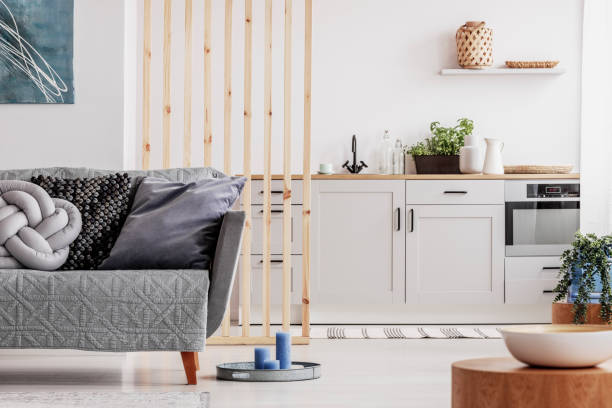 istock Small studio apartment with contemporary kitchen and grey settee, real photo 1162198516