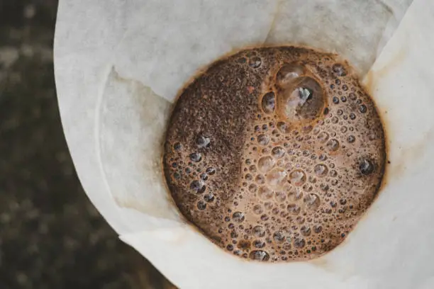 coffee bubbling as it is brewed through a filter top down shot
